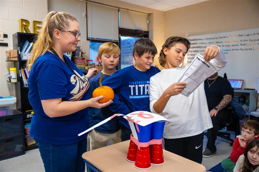 Students do a pumpkin STEM challenge